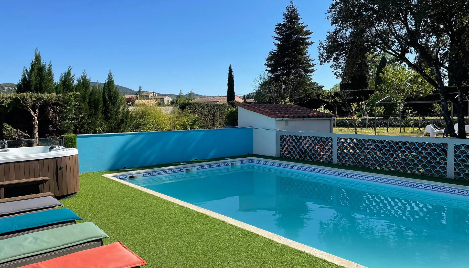 Pool and hot tub seen from the sun loungers