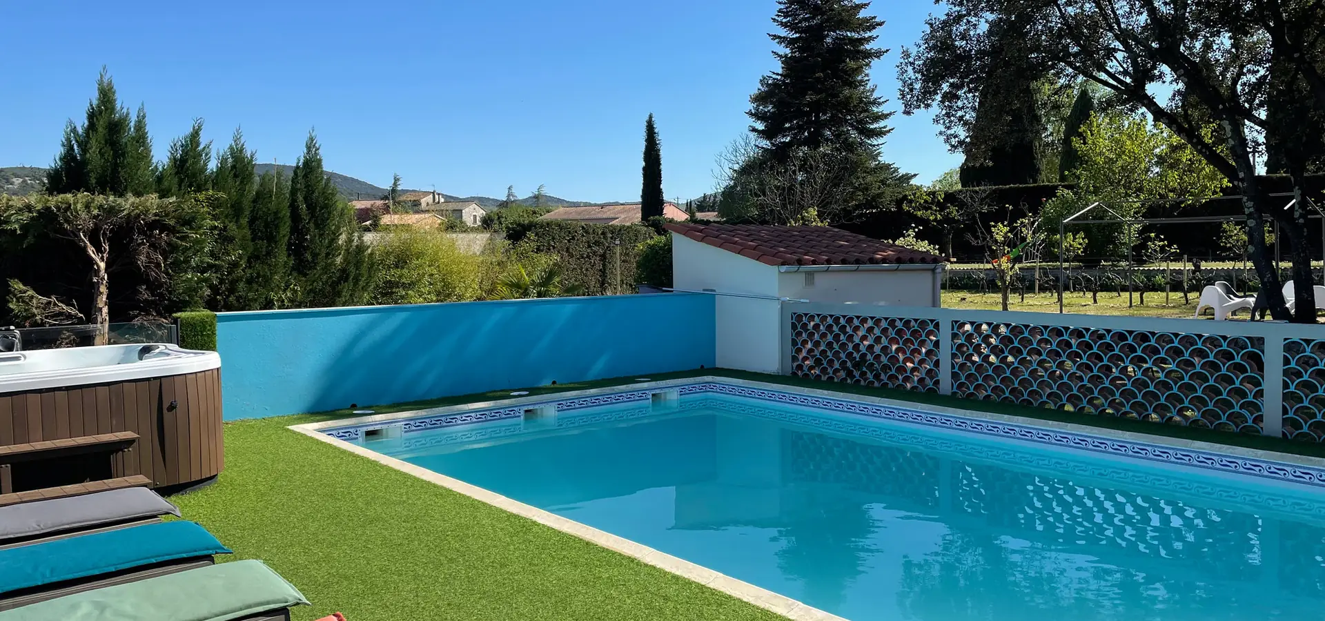 Pool and hot tub seen from the sun loungers