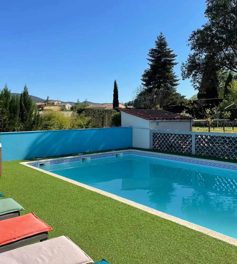 Pool and hot tub seen from the sun loungers